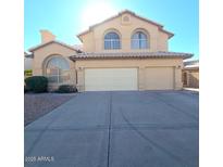 Two-story house with three-car garage and a large driveway at 12419 W Monte Vista Rd, Avondale, AZ 85392