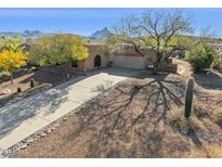 Single-story home with a long driveway, desert landscaping, and mountain views at 16837 E Lunar Ln, Fountain Hills, AZ 85268