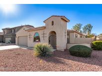 One-story home with attractive facade, desert landscaping, and gated entry at 18970 N Alicante St, Maricopa, AZ 85138