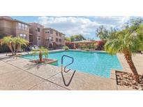 Inviting community pool with palm trees and surrounding patio at 19777 N 76Th St # 2263, Scottsdale, AZ 85255