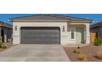 New single-story home with a two-car garage and desert landscaping at 3210 W Stradling Ave, Apache Junction, AZ 85120