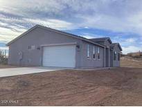 Single-story home with attached garage and desert landscaping at 35810 E Montello Pl, Scottsdale, AZ 85262