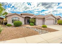 Single-story home with a landscaped front yard, two-car garage, and stone pathway at 4543 E Molly Ln, Cave Creek, AZ 85331