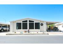 Inviting exterior of manufactured home with carport and landscaping at 5735 E Mcdowell Rd # 38, Mesa, AZ 85215