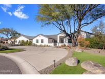 Stunning curb appeal of a single story home with a large driveway and manicured landscaping at 6644 E Cholla Dr, Paradise Valley, AZ 85253