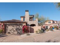 Two-story home with stucco exterior, tile roof, and a large attached garage at 7701 E Golden Eagle E Cir, Gold Canyon, AZ 85118