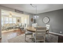 Bright dining area with a rustic wooden table and four chairs at 7950 E Keats Ave # 170, Mesa, AZ 85209