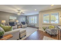 Cozy living room featuring comfortable seating and wood-look tile floors at 7950 E Keats Ave # 170, Mesa, AZ 85209