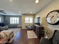 Bright living room with hardwood floors, comfy seating, and large TV at 7950 E Keats Ave # 170, Mesa, AZ 85209