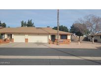 Tan two-unit building with two-car garages and desert landscaping at 8020 E Keats Ave # 314, Mesa, AZ 85209