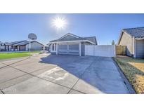 House exterior with artificial turf, fountain, and basketball hoop at 8021 W Charter Oak Rd, Peoria, AZ 85381