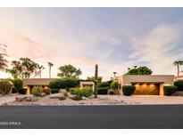 Stunning desert home with a charming courtyard and wooden garage doors at 8408 E La Senda Dr, Scottsdale, AZ 85255