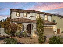 Two-story house with a large driveway and landscaped front yard at dusk at 904 E Zesta Ln, Gilbert, AZ 85297