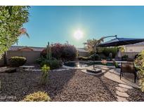 Relaxing backyard oasis with a sparkling pool and patio furniture at 9345 E Hobart St, Mesa, AZ 85207