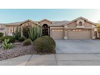 Single-story house with desert landscaping and a two-car garage at 9345 E Hobart St, Mesa, AZ 85207