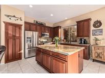 Kitchen boasts granite island and stainless steel appliances at 9345 E Hobart St, Mesa, AZ 85207