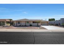 Single-story home with a two-car garage and landscaped front yard at 9719 W Pineridge Dr, Sun City, AZ 85351