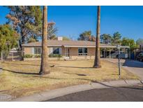 Ranch style home with carport and mature landscaping at 1019 E Belmont Ave, Phoenix, AZ 85020