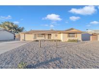 Ranch style home with gravel landscaping and a two-car garage at 10314 W Sun City Blvd, Sun City, AZ 85351