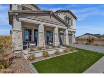 Two-story house with front porch, landscaping, and driveway at 1115 E Gleneagle St, Chandler, AZ 85249