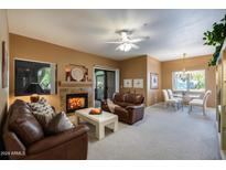 Spacious living room with fireplace and comfortable leather sofas at 15050 N Thompson Peak Pkwy # 1059, Scottsdale, AZ 85260