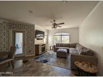 Spacious living room with L-shaped sectional sofa and a fireplace at 15095 N Thompson Peak Pkwy # 1047, Scottsdale, AZ 85260