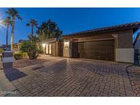 Attractive single-story home with a brick driveway and two-car garage at 16169 W Fairmount Ave, Goodyear, AZ 85395