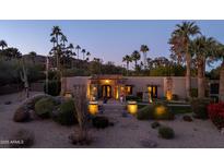 Stunning home exterior at dusk with palm trees and landscape lighting at 4836 E Moonlight Way, Paradise Valley, AZ 85253