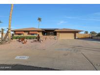 Single story home with a landscaped yard and two-car garage at 9101 W Willow Haven Ct, Sun City, AZ 85351