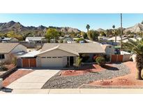 Single-story home with landscaped yard and mountain views at 10618 N 27Th St, Phoenix, AZ 85028