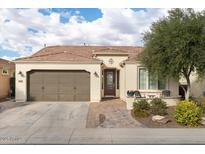 Charming single-story home featuring a tile roof, landscaped front yard, and attached two-car garage at 1364 E Elysian Pass, Queen Creek, AZ 85140