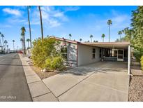 Single-wide manufactured home with carport and desert landscaping at 150 S Windsor -- # F87, Mesa, AZ 85204