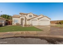 Two-story house with three-car garage and landscaped lawn at 16000 W Sherman St, Goodyear, AZ 85338