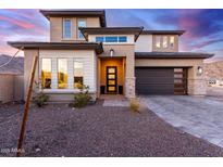 Two-story home with modern design, stone accents, and a three-car garage at 21632 W Hillcrest Blvd, Buckeye, AZ 85396