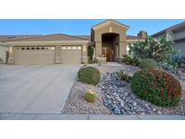 Beautiful desert landscape surrounds this single-story home with a three-car garage at 23861 N 74Th Pl, Scottsdale, AZ 85255