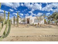 White stucco house with desert landscaping and a spacious front yard at 29619 N 60Th St, Cave Creek, AZ 85331