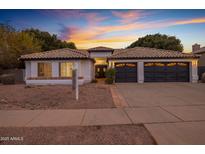 Stunning curb appeal of this single-story home, featuring a two-car garage and landscaped yard at 3077 W Ironwood Cir, Chandler, AZ 85226