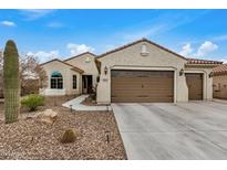 Single-story home with two-car garage and desert landscaping at 3677 N Hudson Dr, Florence, AZ 85132