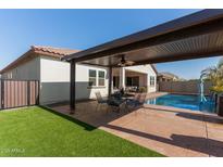 Covered patio with seating area and pool view at 41925 W Arvada Ln, Maricopa, AZ 85138