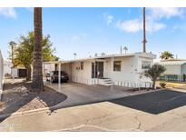 Single-wide manufactured home with carport and paved driveway at 530 S Alma School Rd # 75, Mesa, AZ 85210