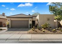 Single-story home with desert landscaping and a two-car garage at 6963 E Bramble Berry Ln, Scottsdale, AZ 85266