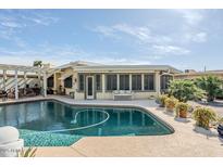 Backyard pool and patio area is perfect for outdoor living and entertaining at 10814 W Palmeras Dr, Sun City, AZ 85373