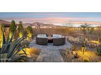 Spacious backyard patio with circular seating area and fire pit, perfect for outdoor entertaining at 12465 E Soloman Rd, Gold Canyon, AZ 85118