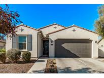 Single-story home with gray garage door and landscaping at 12746 N 145Th Ln, Surprise, AZ 85379