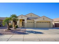 Attractive single-story home with a three-car garage and desert landscaping at 226 S 122Nd Ln, Avondale, AZ 85323