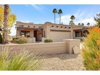 Tan stucco home with a two-car garage and desert landscaping at 25615 N Bolero Bnd # 2, Rio Verde, AZ 85263