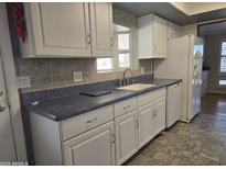 White cabinets, blue countertop kitchen at 2650 W Union Hills Dr # 33, Phoenix, AZ 85027