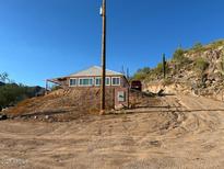 Ranch style home with large windows and deck overlooking desert landscape at 2960 W Tonto St, Apache Junction, AZ 85120
