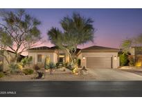 Desert landscape enhances curb appeal of this single-story home with two-car garage at 33286 N 71St St, Scottsdale, AZ 85266