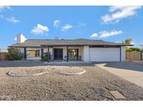 Single-story home with white exterior, two-car garage, and landscaped front yard at 4524 E Walatowa St, Phoenix, AZ 85044
